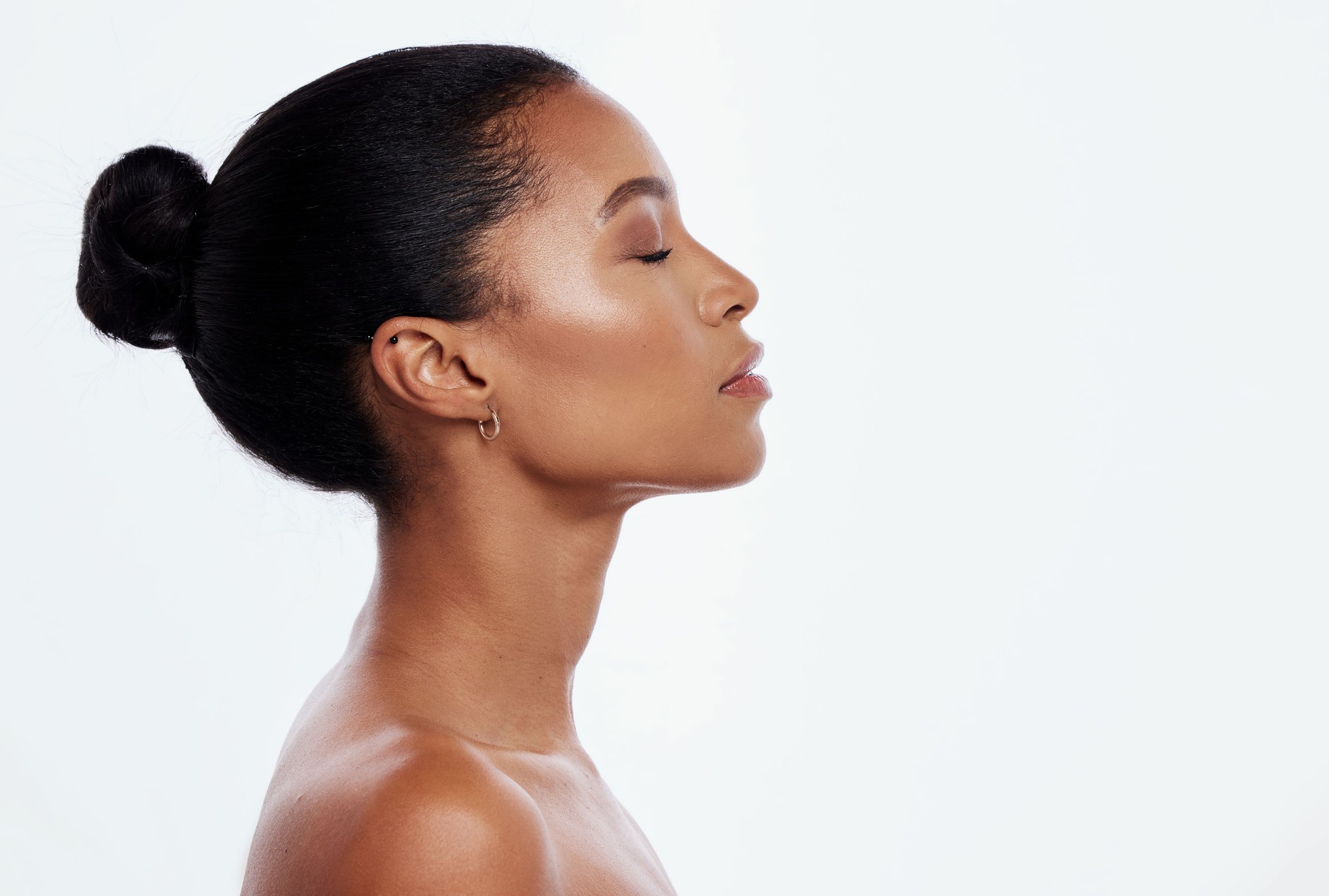 Black woman, facial profile and beauty in studio, isolated white background and mockup. Female model, face side and dermatology for skincare, aesthetic makeup and natural cosmetics for salon wellness